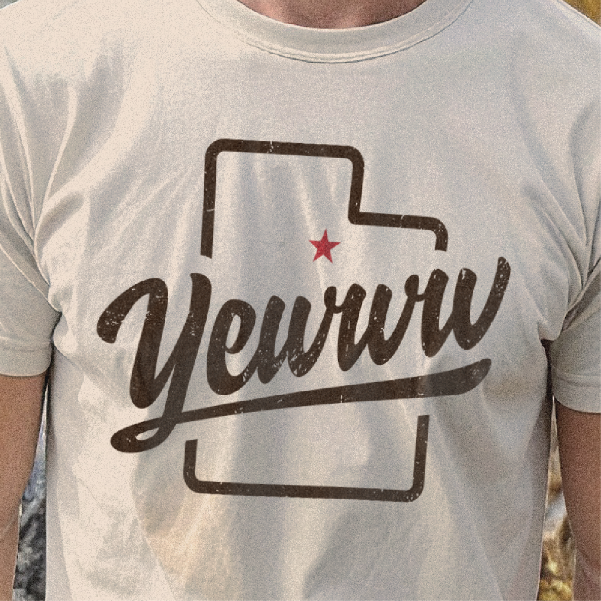 T-shirt with a graphic design of the state of Utah outline and 'Yewww' text on a neutral background