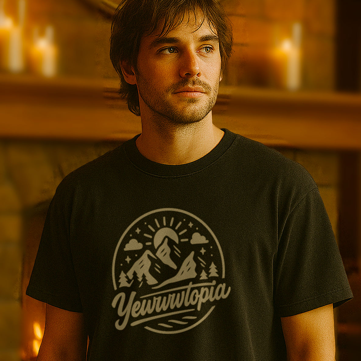 Man wearing a black t-shirt with 'YewwWtopia' design in a warm-toned room.