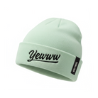 Mint green beanie with embroidered 'Yewww' branding on a white background