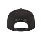 Black flat bill cap with embroidered 'Park City, UT' text on the back against a white background
