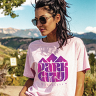 Woman wearing a pink t-shirt with 'Park City' design outdoors in Park City, UT