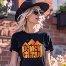 Woman wearing a black t-shirt with 'Park City' graphic design outdoors.