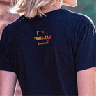 Person wearing a black t-shirt with 'YEWWTAH' logo on the back