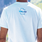 Light blue t-shirt with 'YEWWMTAH' logo on the back, worn by a person outdoors.