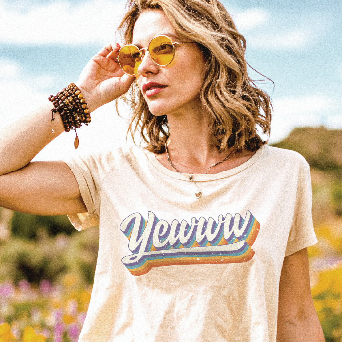 Woman wearing the Yewwwtah Rainbow Yewww t-shirt with sunglasses outdoors