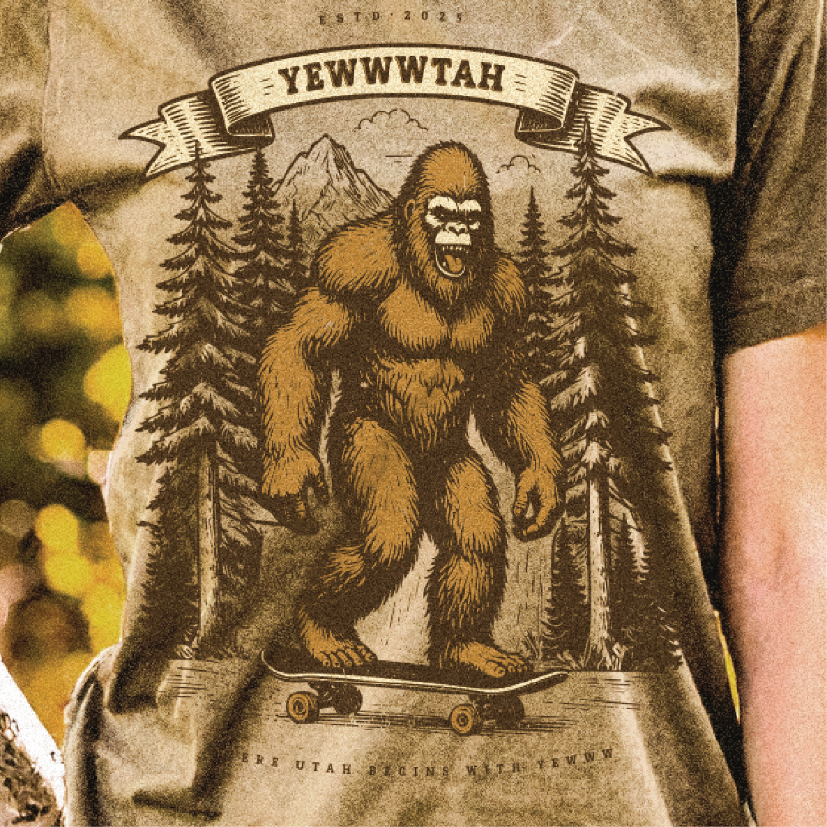 T-shirt with a graphic of a yeti / sasquatch on a skateboard and trees, with 'YEWWWTAH' text above.