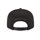 Black flat bill cap with embroidered 'Park City' text embroidered on a white background