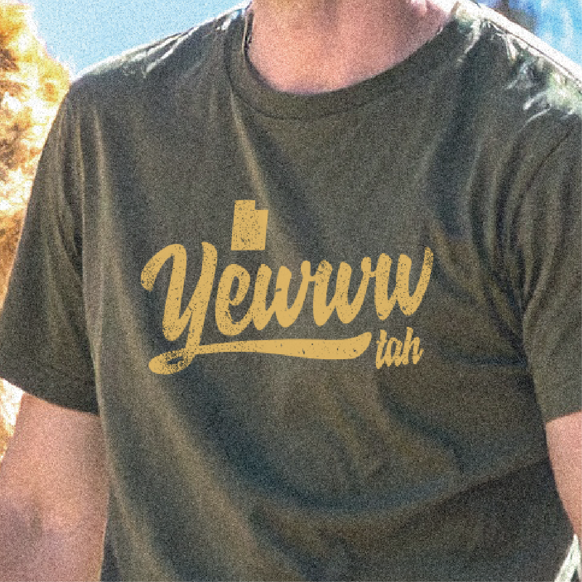 Person wearing a green t-shirt with 'Yewww' printed in yellow.